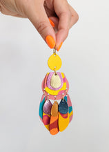 Load image into Gallery viewer, Brightly coloured pink and yellow statement earrings made from painted leather. 
