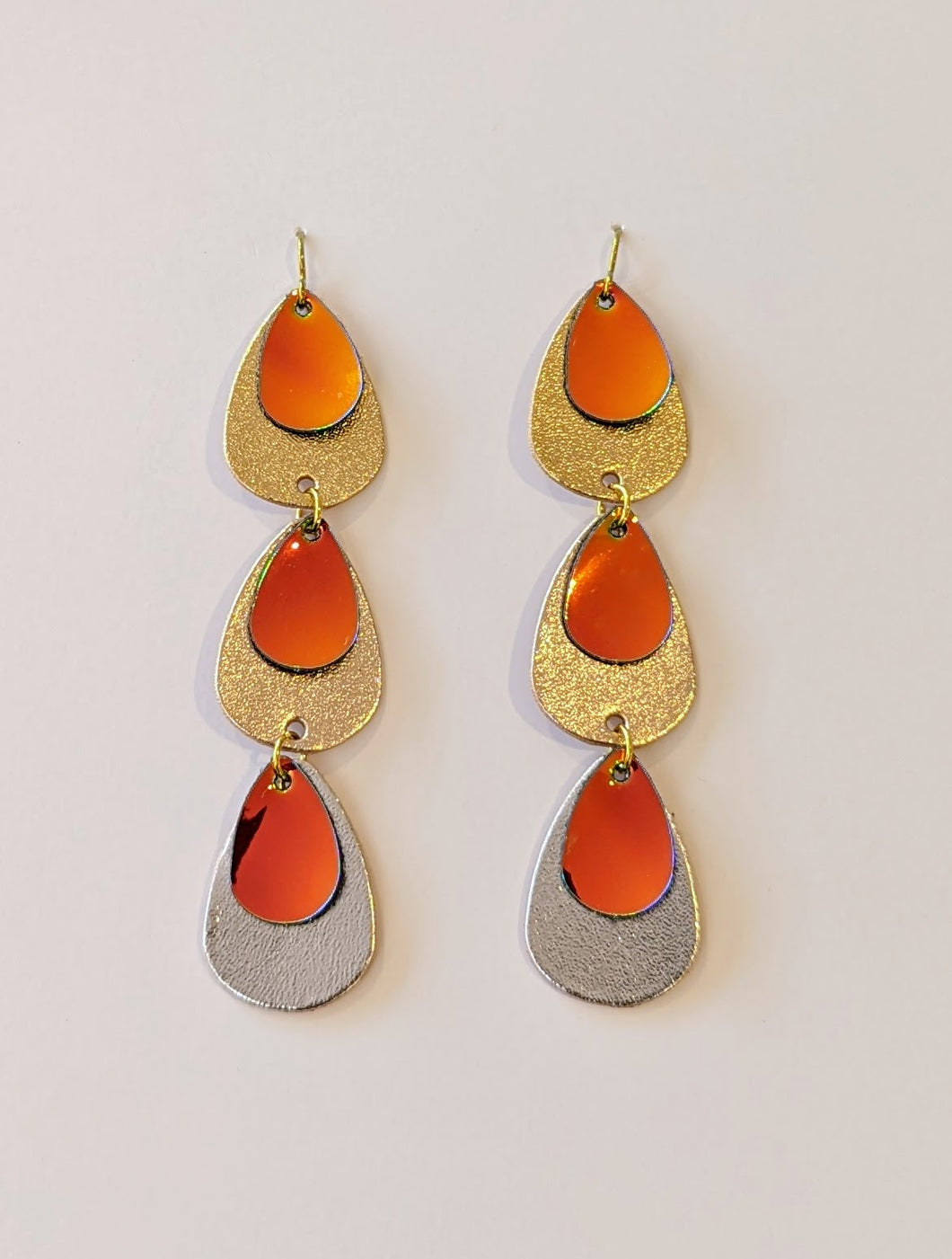 Metallic leather earrings made from silver, gold and rose gold leathers in a long drop shape.